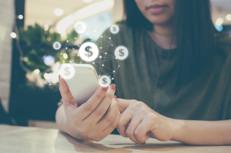 Frau bezahlt online über ihr Handy